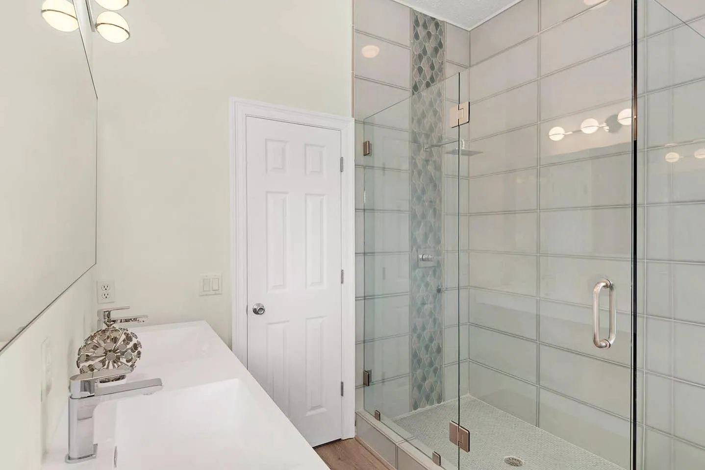 Modern bathroom remodel with stone counter and tile shower